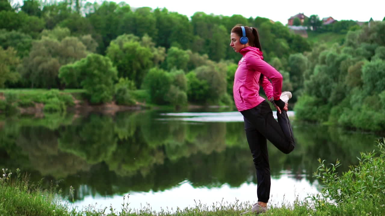 la chica se calienta temprano en la mañana antes del entrenamiento preparándose para una carrera en el sol