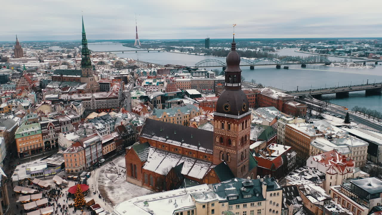 Aerial shot of drone flying around the St. Peter Church in Riga at winter
