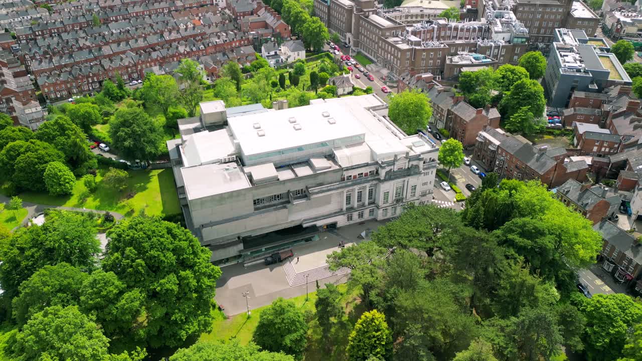 Rising aerial video of Ulster Museum in Botanic Gardens in Belfast, Northern Ireland on a bright sunny day. Produced in 4K, 30 frames per second and with Rec709 color.