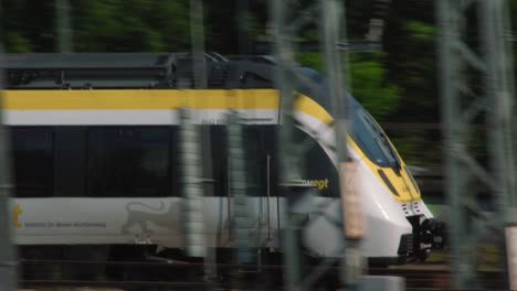 german bwegt passenger train passing by tracked by camera closeup