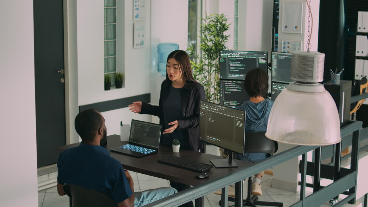 Diverse coders talking about source code on terminal window