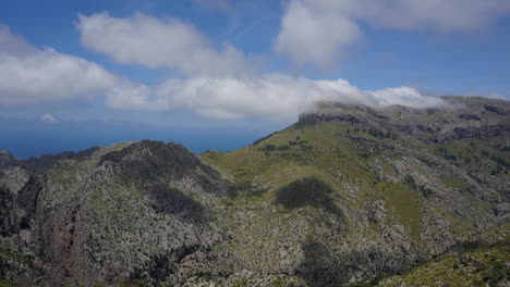 time lapse: clouds passing by over mountains on a sunny island