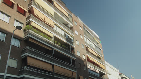 Beautiful medium shot of the balconies of a neighborhood building in Madrid during a sunny day.