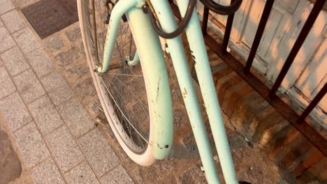 the vibrant blue bicycle is stationed on the sidewalk, illustrating the concept of urban mobility and eco-friendly transportation
