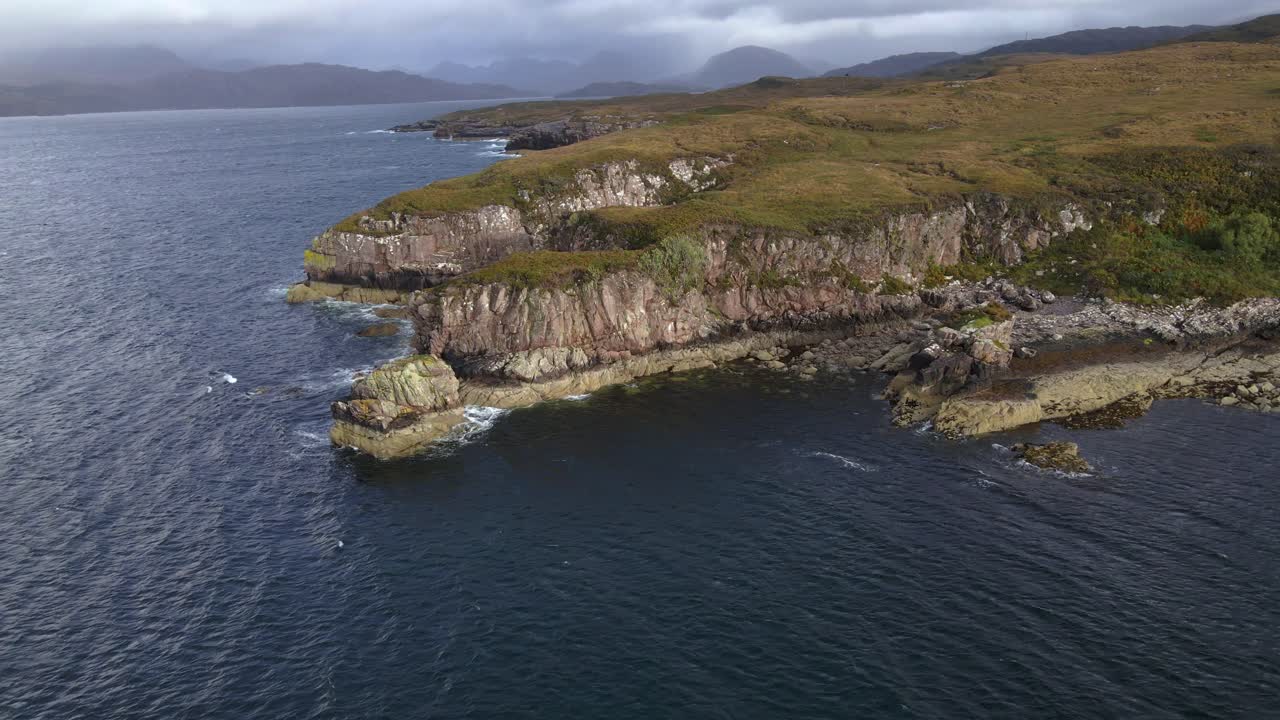 Drone shot flying around rock formations on the coast of the Applecross peninsula in the Scottish highlands.