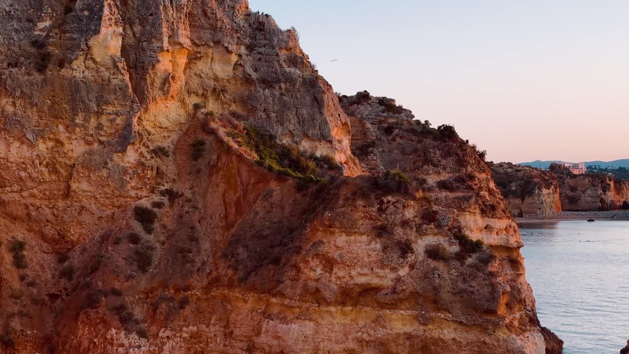 Exploring rocky coastal cliffs in Portugal at sunset