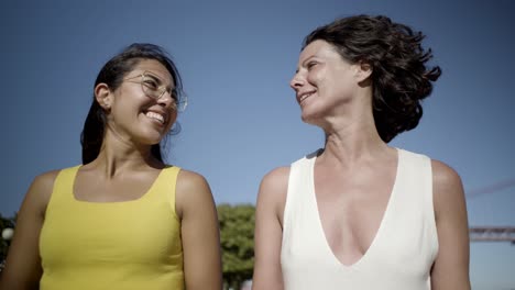 happy female friends walking outdoor