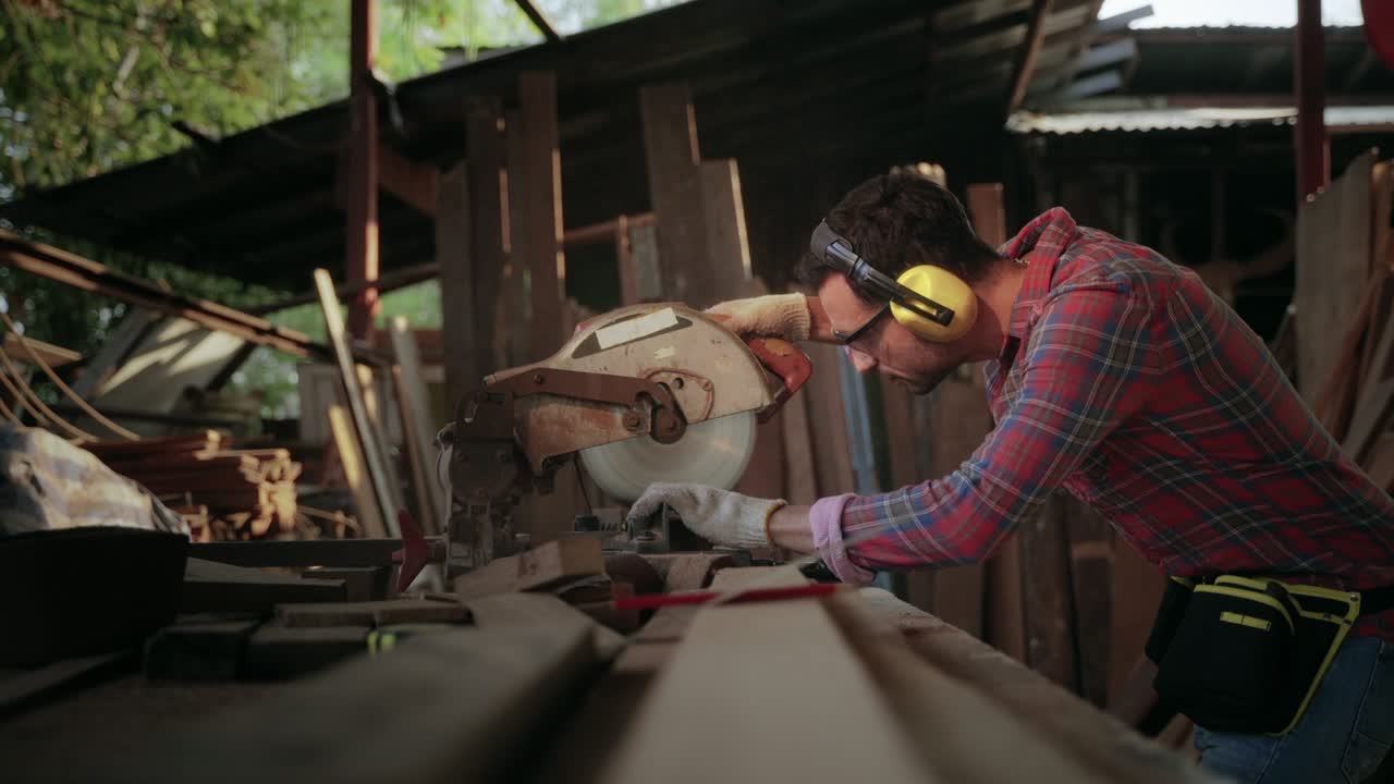 Carpenters cut work pieces with electric saws, craft furniture.