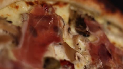 close up of a delicious mushroom and prosciutto pizza