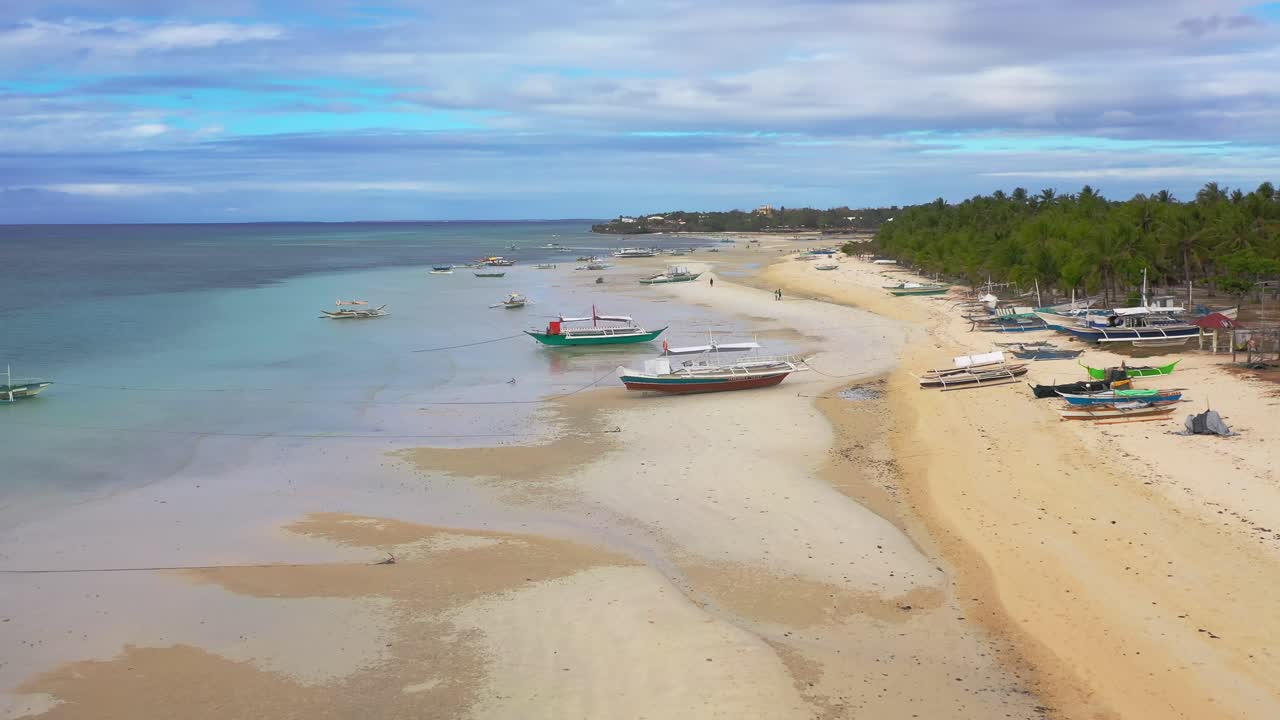 Magnificent high aerial panoramic flight over Boracay island beach, boats and people, Philippines