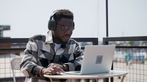 man working on a laptop outdoors