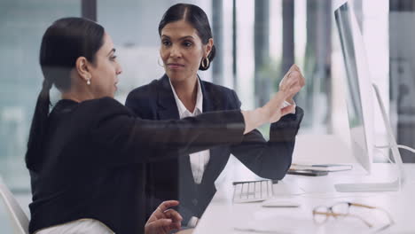 two-businesswomen-working-together-on-a-computer