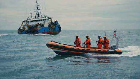 a small boat with crew approaching a distressed ship at sea