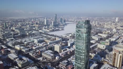 winter cityscape aerial view with skyscrapers and frozen river