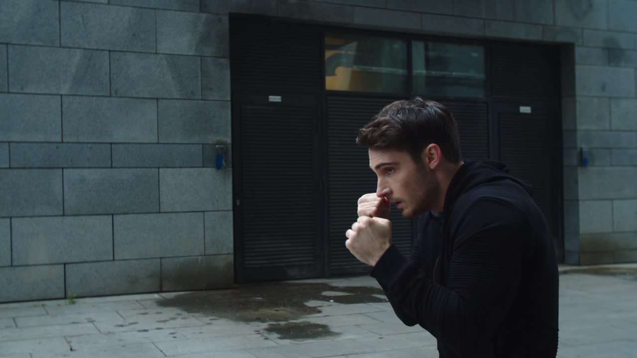 Male boxer training fist punch outdoor. Closeup sportsman training box kick.