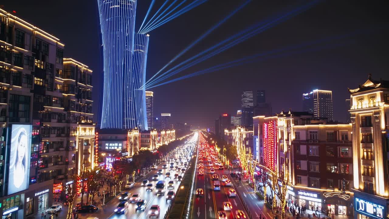 Powerful light beams illuminate the night sky from a modern skyscraper overlooking a bustling city street filled with traffic, showcasing the vibrant energy of urban life after dark
