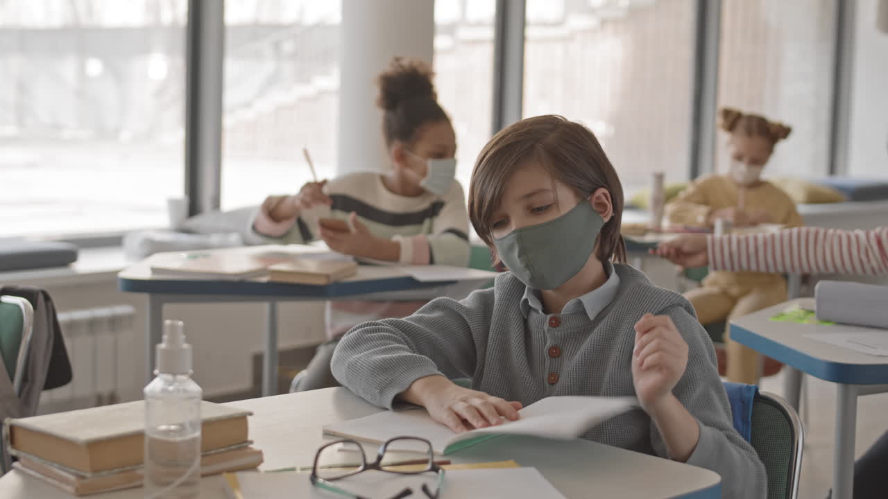 Teenage Boy Using Sanitizer at School