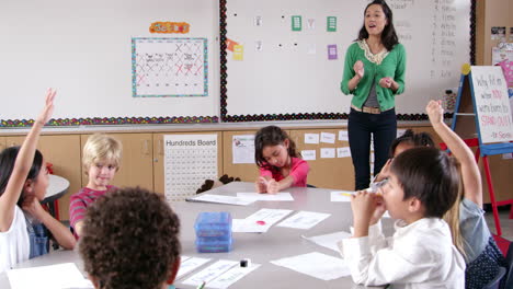 Mujer-Asiática-Enseñando-A-Niños-Pequeños-En-La-Clase-De-Escuela-Primaria