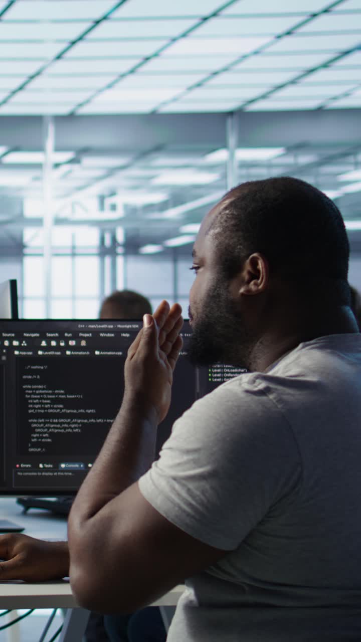 Tired African American Programmer Yawning While Working on Computer