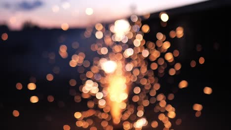 60 frames per second shot of fireworks going off on the ground, as the flames are intentionally out of focus creating beautiful bokeh bubbles and blurring