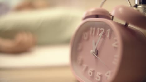 pink alarm clock on a desk