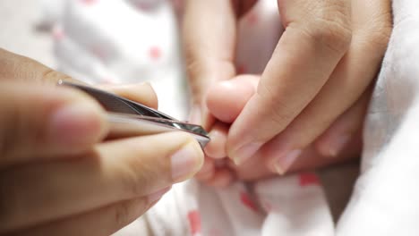 a caring moment as a girl carefully trims her baby's nails at home emphasizing love and attention.