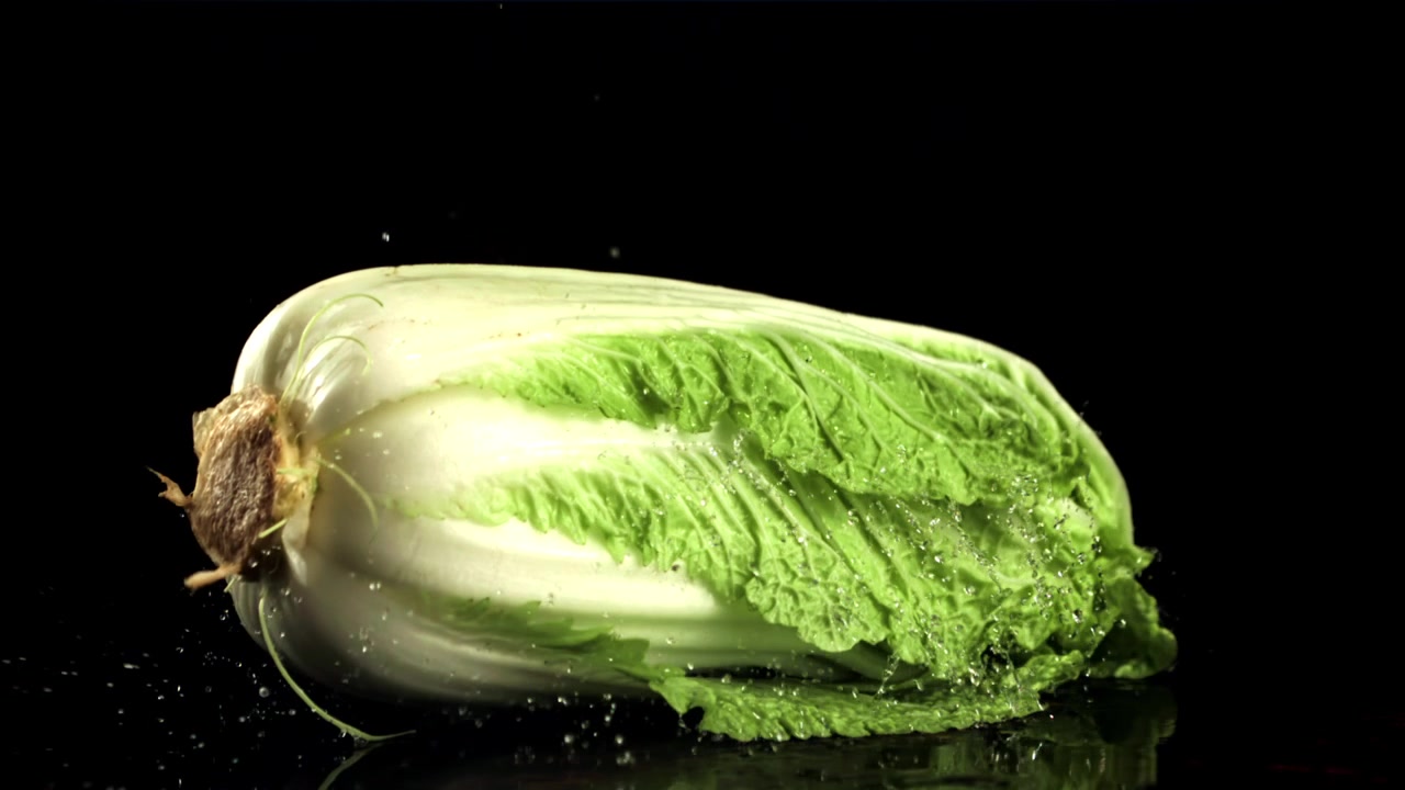 Fresh Chinese Cabbage Falling and Splashing Water in Slow Motion