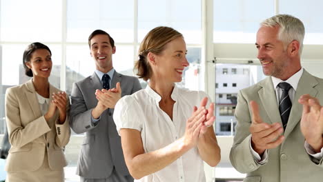 Business-people-clapping-at-the-camera