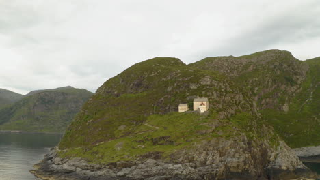 tranquil scenery of hendanes lighthouse in vagsvag region near maloy at the coast of norway - aerial drone shot