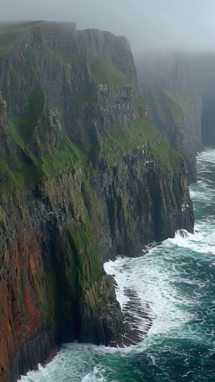 Majestic Cliffs Overlooking Turbulent Waters: A Serene View of Nature's Splendor Amidst the Misty Atmosphere and Crashing Waves