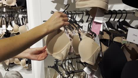 a young woman buys a bra in a lingerie store. shopping in stores.