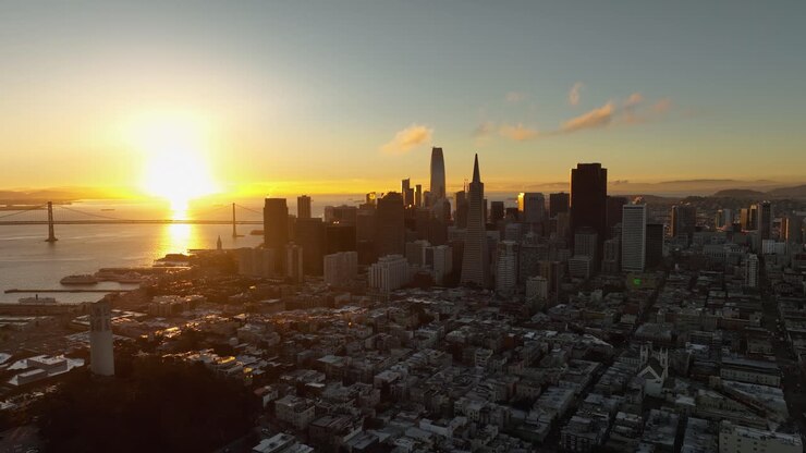 Bright golden sunbeam reflects on San Francisco Bay and the city skyline at dawn