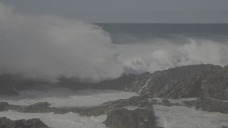 powerful ocean waves crashing against rocks