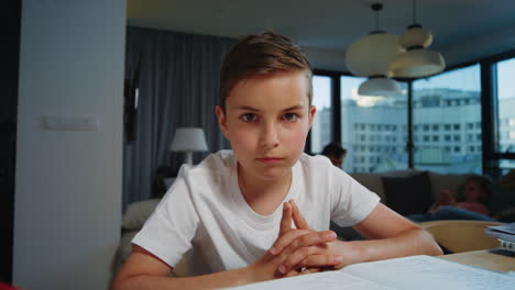 Cute-kid-nodding-head-during-online-lesson.-Clever-boy-looking-camera-indoors.