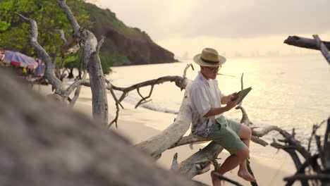 4k happy asian businessman working on digital tablet while travel at tropical beach.