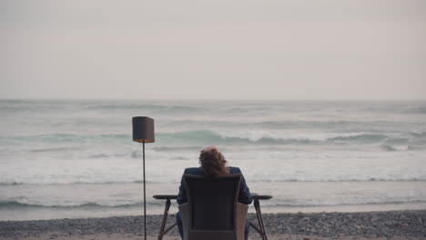 man chilling on isolated beach