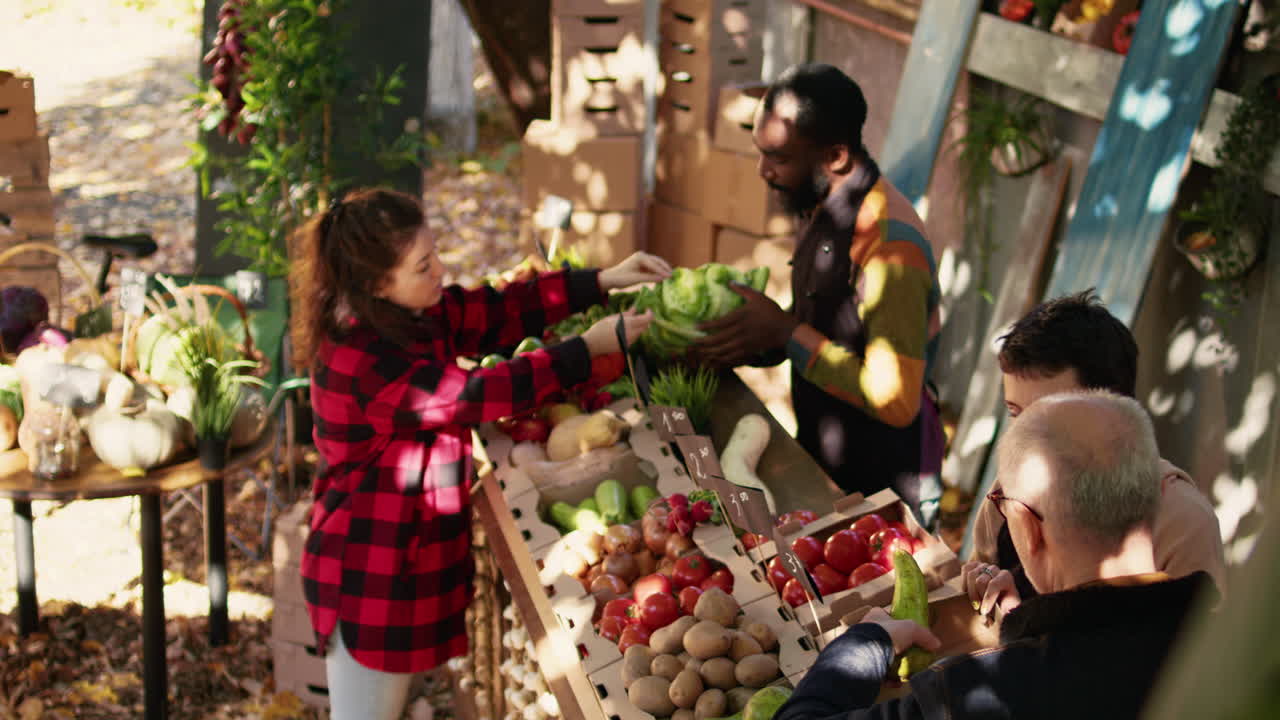 People buying fresh produce at a farmers market
