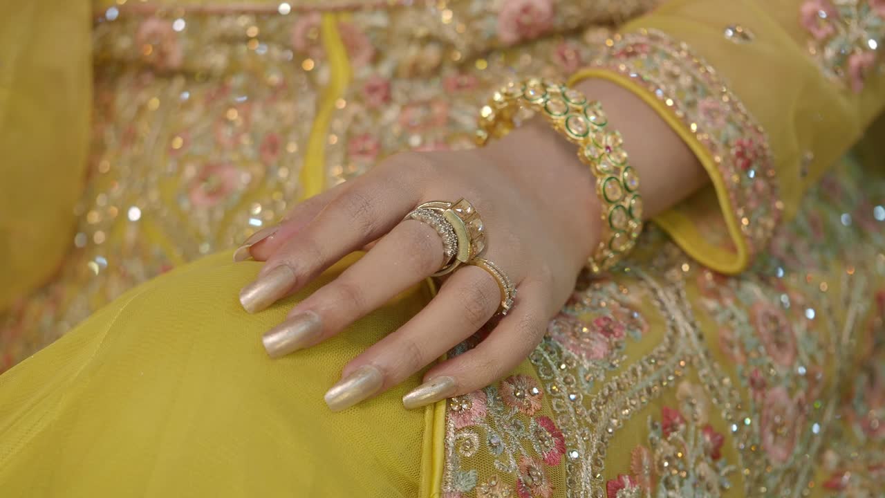 Woman's Hand with Jewelry and Yellow Dress