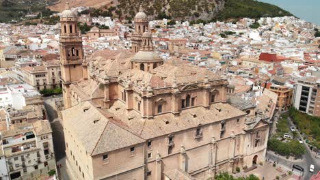 Spain-Jaen-Cathedral,-Catedral-de-Jaen,-flying-shoots-of-this-old-church-with-a-drone-at-4k-24fps-using-a-ND-filter-also-it-can-be-seen-the-old-town-of-Jaen