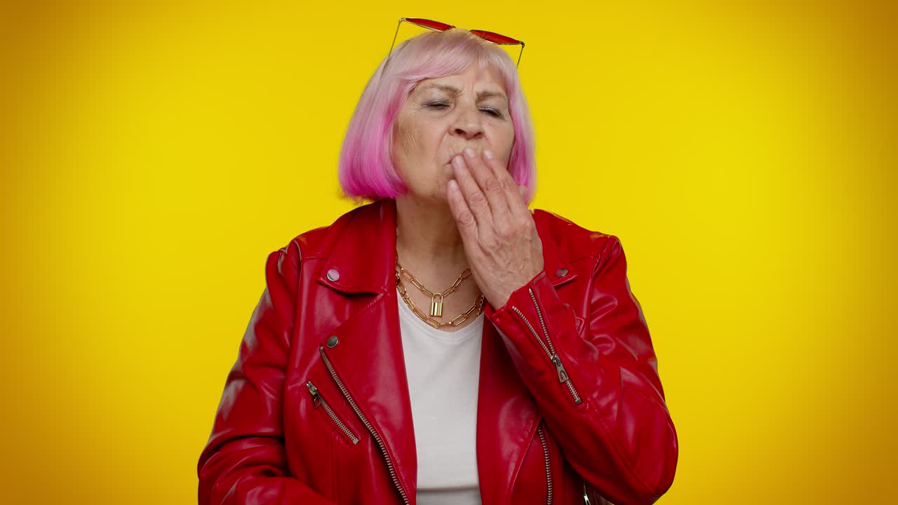 Smiling romantic senior woman sending lots of air kisses looking at camera and smiling, missing you