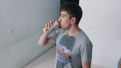 man drinking beer in a room