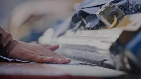 close up shot of machinist processing leather on a industrial machine in a production workshop