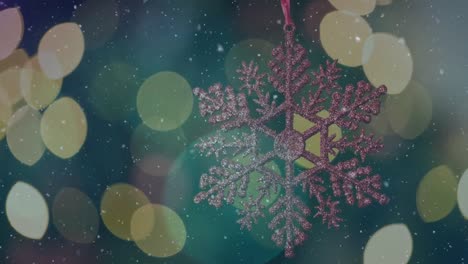 Animation-of-snow-falling-and-light-spots-over-christmas-decorations