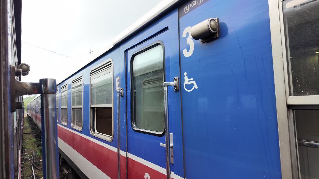 Close-up of a Blue and Red Train Car with Wheelchair Symbol