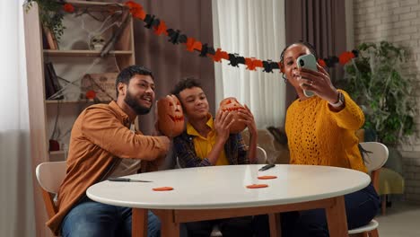 family carving halloween pumpkins