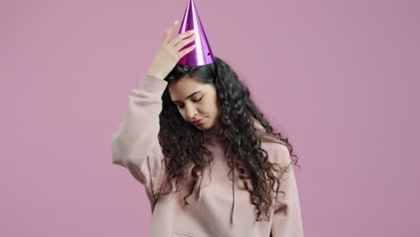 sad woman wearing party hat
