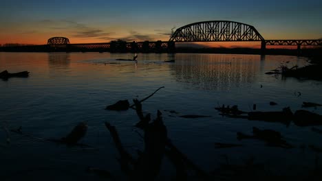 a bridge spans the ohio river near louisville kentucky at dusk 1