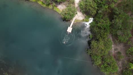 aerial-view-of-man-diving-in-Olhos-d'água,-Vale-do-Pati,-Chapada-Diamantina,-Bahia,-Brazil