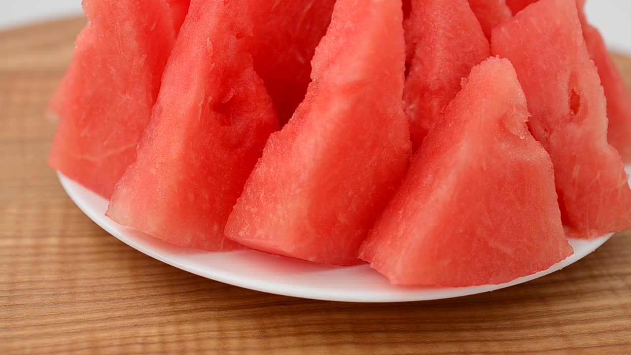 Shooting of a watermelon on a kitchen board. Shooting in the movement