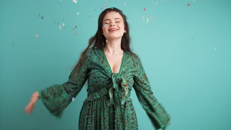 cheerful young woman throwing confetti up in air